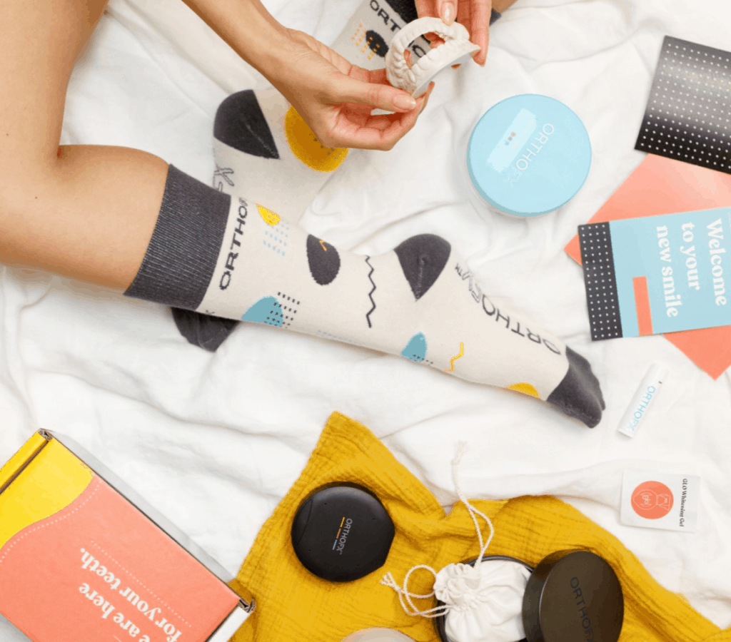 women wearing OrthoFx socks and unboxing dental product | OrthoFx